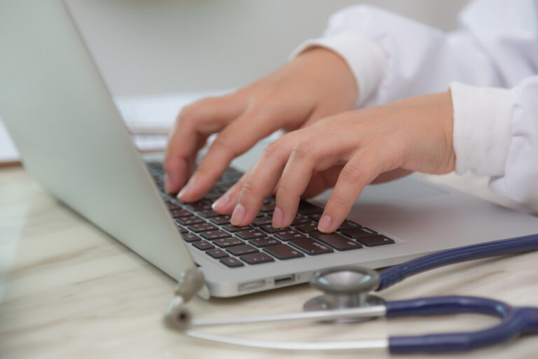close-up-doctor-s-hands-typing